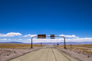 Welcome to Argentina Border crossing between San Pedro de Atacama and Fiambala in the Atacama Desert, featuring a dirt ro.
