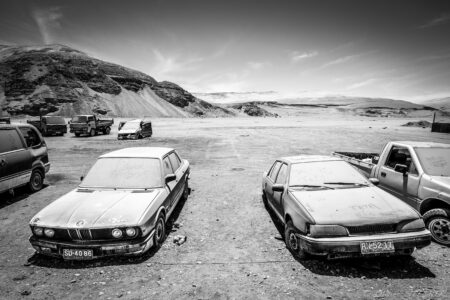 Atacama Desert Desert landscape with vintage cars in Fiambala, Argentina, showcasing rugged terrain and open skies.