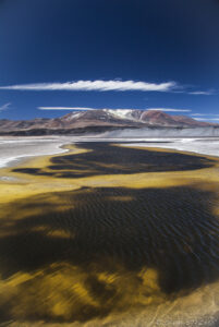 Around - A côté de la - Laguna Verde Desert landscape in Fiambala, Argentina, with colorful salt flats, mountains, and a clear blue sky.