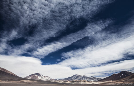 Nevado Ojos del Salado Fiambala mountain landscape with dramatic clouds over rugged terrain in Argentina.