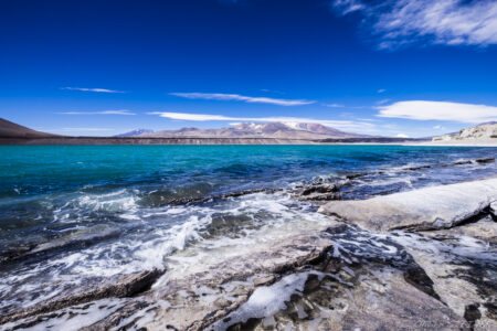 Laguna Verde Fiambala Lake, Argentina, with clear blue waters and rugged mountains in the background, captured by.