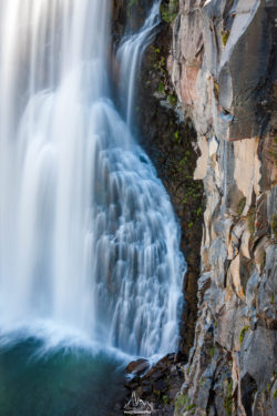 Stunning waterfall captured in a natural setting, showcasing the beauty of outdoor scenery and flowing water. Waterfall cascading over rocky cliff in a natural landscape.