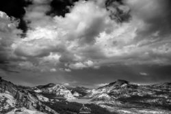Black and white mountain landscape with dramatic cloud formations. Mountain landscape with dramatic clouds in black and white.