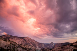 A breathtaking mountain landscape captured during sunset, showcasing dramatic clouds and vibrant colors in the sky, emphasizing natural beauty and lan. Sunset over rugged mountain range with colorful clouds and vibrant sky. Stunning landscape photograp.