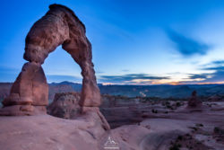 Stunning sunset over Arches National Park featuring the famous Delicate Arch formation. Arches National Park sunset with iconic rock formation and vibrant sky.