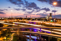 Night city view with busy highways and city lights, captured by Olivier Steiner Photography. Cityscape at dusk with illuminated highways and skyline, Olivier Steiner Photography.